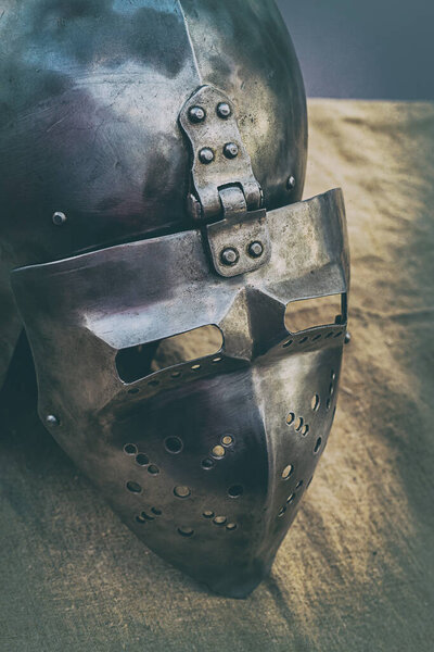 Medieval helmet with a visor to protect the head and face of a warrior close-up