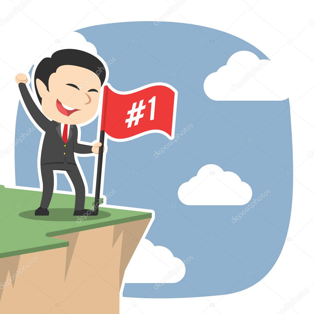 businessman standing with flag on cliff edge