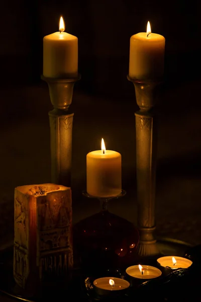 Seven burning candles in the dark — Stock Photo, Image