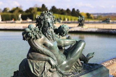 the sculpture of the God Bacchus on a fountain at Versailles clipart
