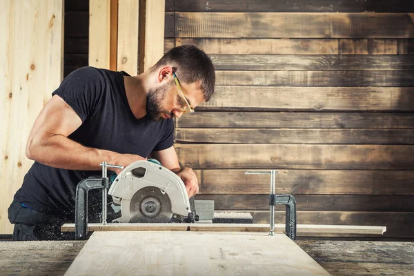 Mann sägt ein breites Holz — Stockfoto