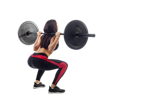 Woman doing squat with a barbell — Stock Photo, Image