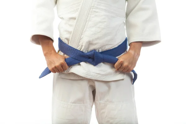 Close-up of a man  in a white kimono for judo, ties up a blue be — Stock Photo, Image