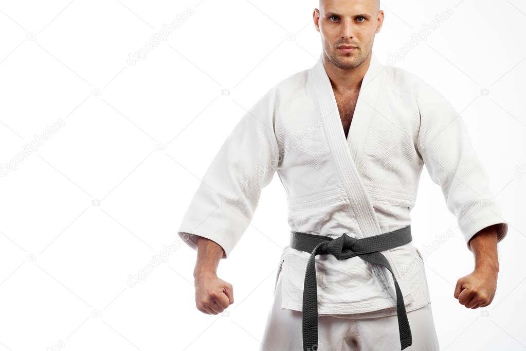 man in white kimono posing on white background