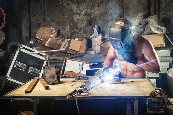 man welding a metal with arc welding machine 