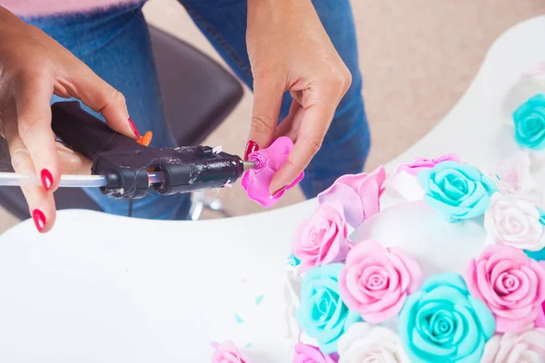 woman making artificial rose