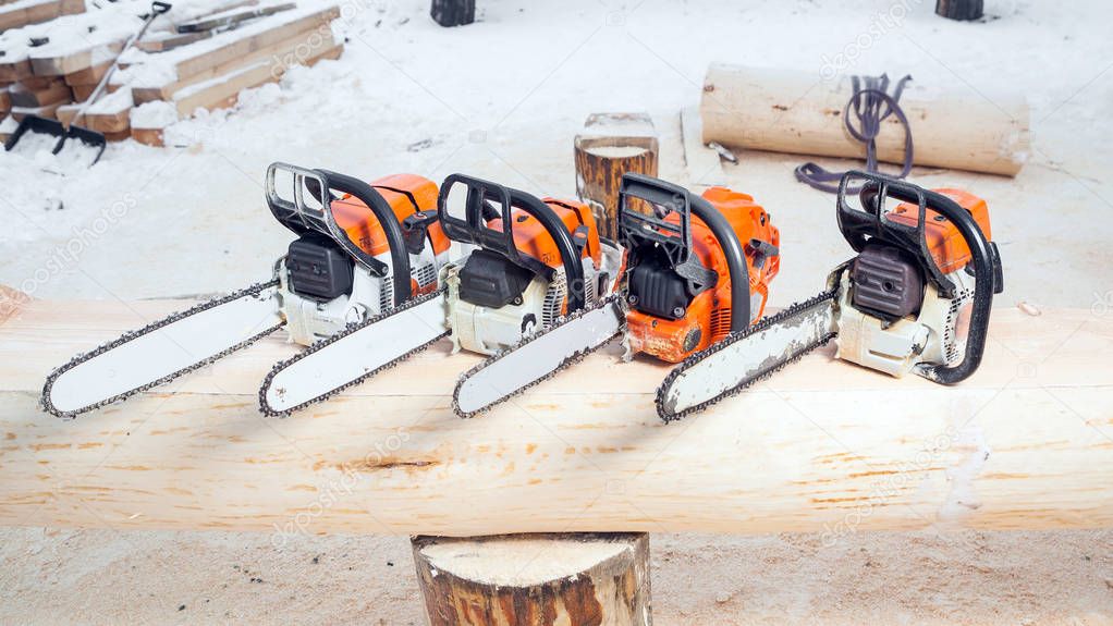 Close-up of four hand-held circular saws