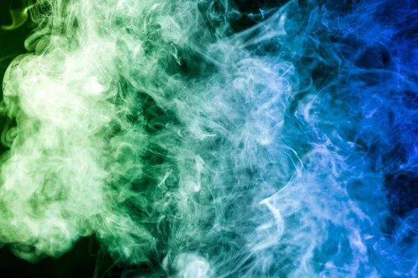 Colorful  green and blue  smoke clouds on dark background.Background of smoke vape
