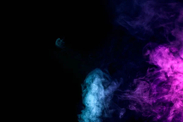 Dense multicolored smoke of   red and blue colors on a black isolated background. Background of smoke vape