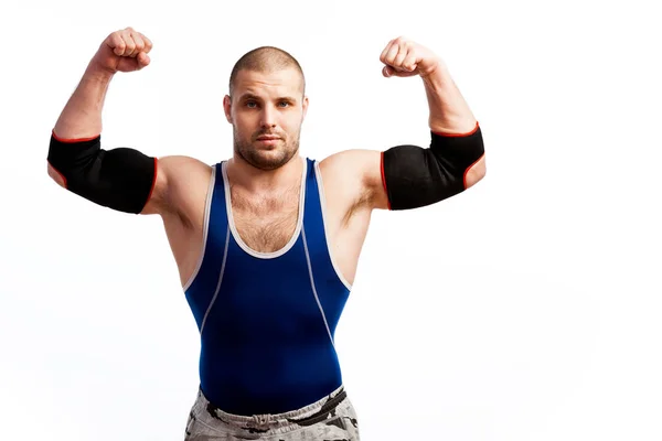 Pemuda Atletik Dengan Celana Ketat Biru Dan Siku Hitam Berdiri — Stok Foto