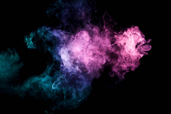 Colorful smoke of blue, pink, green on a black isolated background. Background from the smoke of vape