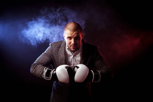 man businessman in gray suit and boxing gloves