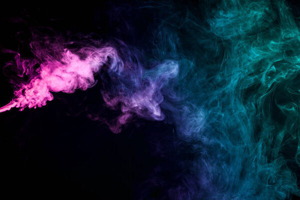 Pink and blue cloud of smoke of black isolated background. Background from the smoke of vape