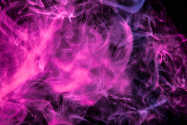 Thick colorful smoke of pink on a black isolated background. Background from the smoke of vape