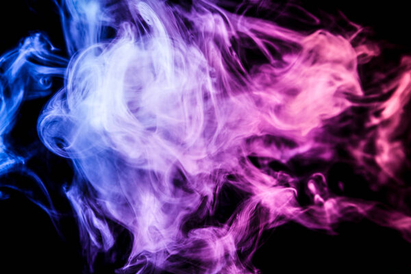 Dense multicolored smoke of blue and pink colors on a black isolated background. Background of smoke vape