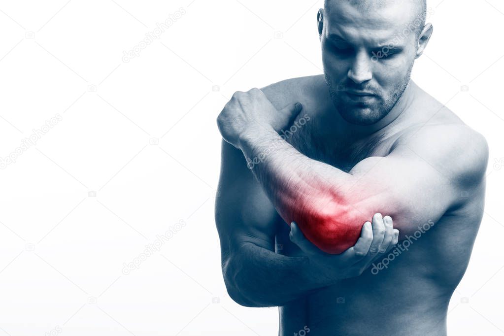 Injury of the elbow. Young bald man sports physique holds a sick elbow on a white isolated background