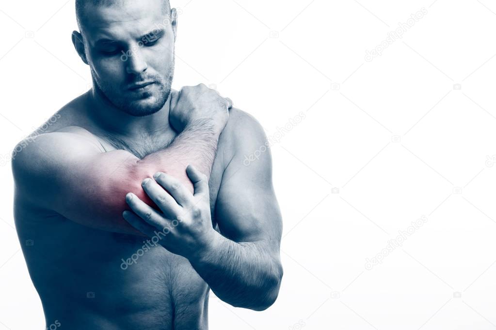 Injury of the elbow. Young bald man sports physique holds a sick elbow on a white isolated background