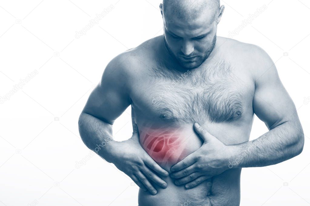 Injury of the rib. Young bald man sportive physique holds on sore rib isolated on white isolated background. Fracture of rib
