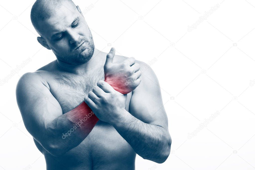 Injury of the hand. Young bald man sportive physique stretched and clings to a sick hand on a white isolated background. Stretching the hand
