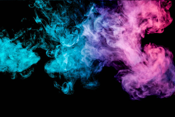 Thick pink and blue colorful smoke of on a black isolated background. Background from the smoke of vape