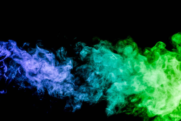 Colorful smoke of pink and blue on a black isolated background. Background from the smoke of vape