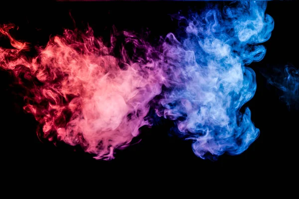 Thick blue and red colorful smoke of on a black isolated background. Background from the smoke of vape