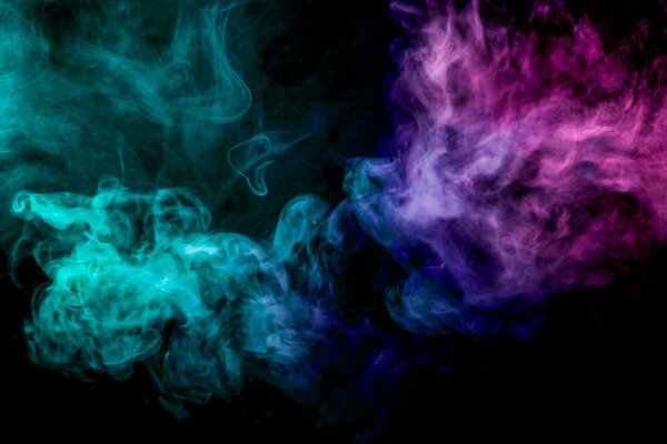 Dense multicolored smoke of pink and blue colors on a black isolated background. Background of smoke vape