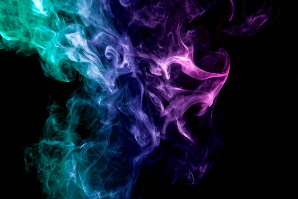 Green, blue and purple cloud of smoke of black isolated background. Background from the smoke of vape