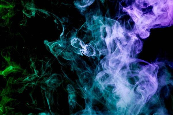 Green, blue and purple cloud of smoke of black isolated background. Background from the smoke of vape