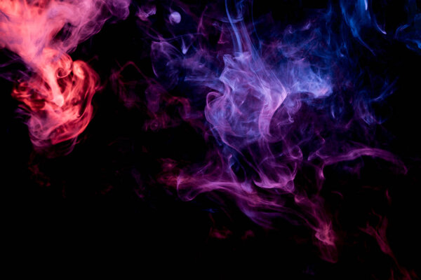 Pink, red and blue cloud of smoke of black isolated background. Background from the smoke of vape