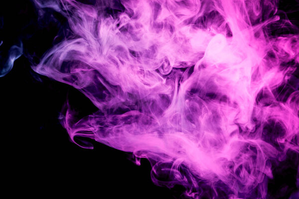 Thick colorful smoke of pink on a black isolated background. Background from the smoke of vapee