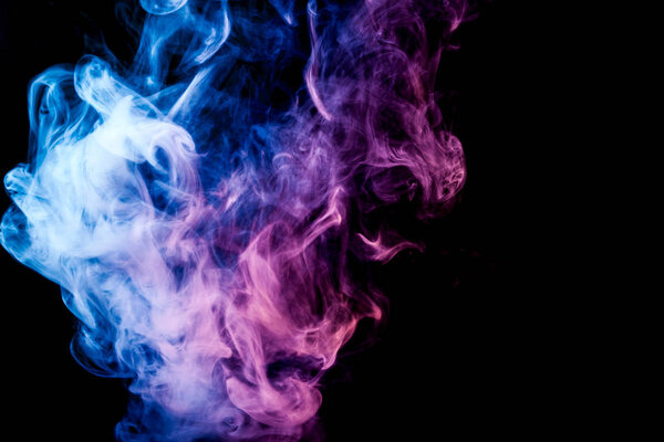 Thick blue and pink colorful smoke on a black isolated background. Background from the smoke of vape