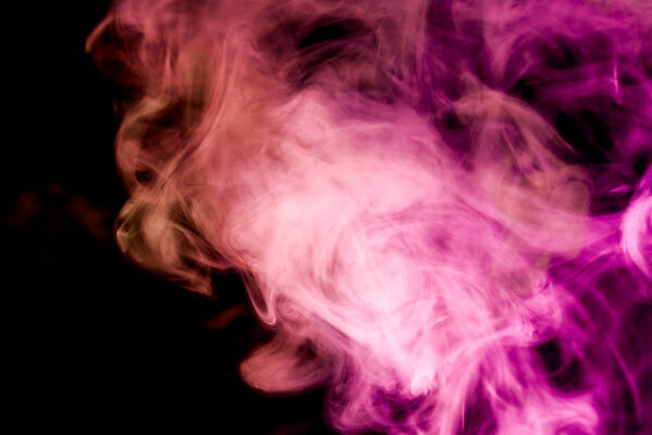 Thick colorful smoke of pink and red on a black isolated background. Background from the smoke of vape