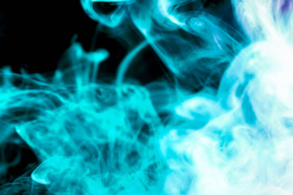 Colorful blue and purple smoke on a black isolated background. Background from the smoke of vape