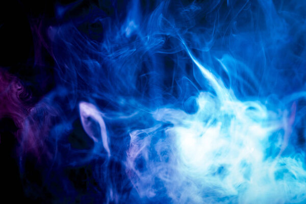 Colorful blue and purple smoke on a black isolated background. Background from the smoke of vape
