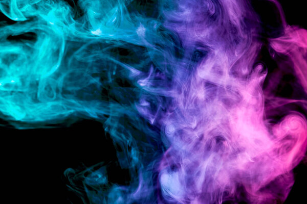 Colorful blue, green and pink smoke on a black isolated background. Background from the smoke of vape