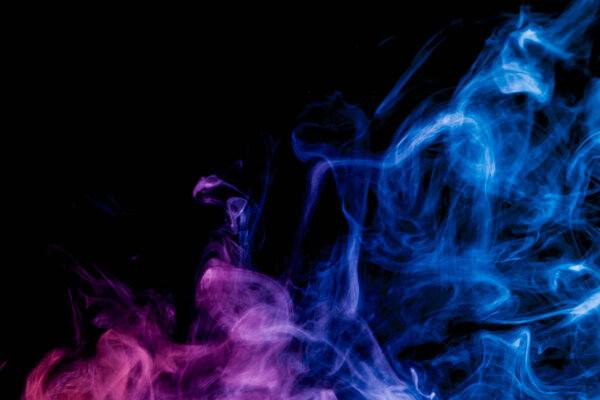 Blue and pink smoke on black background