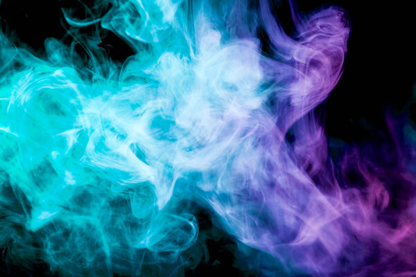Colorful blue and pink smoke on a black isolated background. Background from the smoke of vape