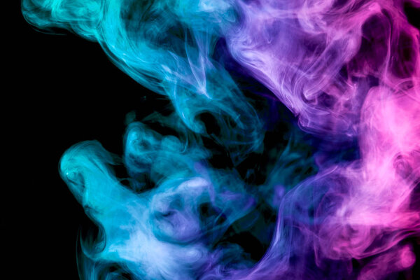Thick colorful smoke of blue, pink and purple on a black isolated background. Background from the smoke of vape