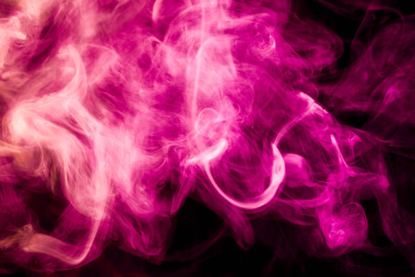 Colorful red smoke on a black isolated background. Background from the smoke of vape