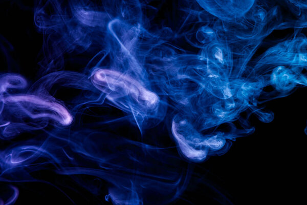 Blue and purple cloud of smoke of black isolated background. Background from the smoke of vape