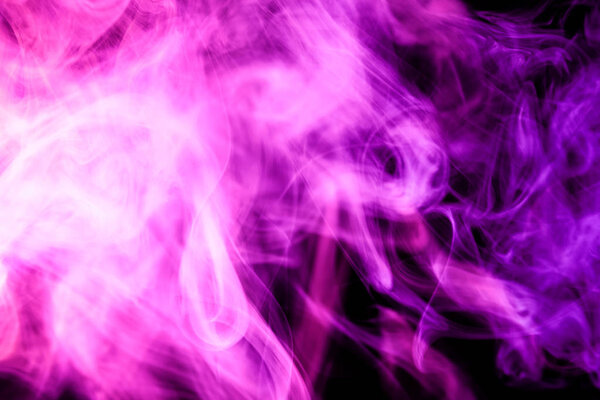 Thick colorful pink smoke on a black isolated background. Background from the smoke of vape