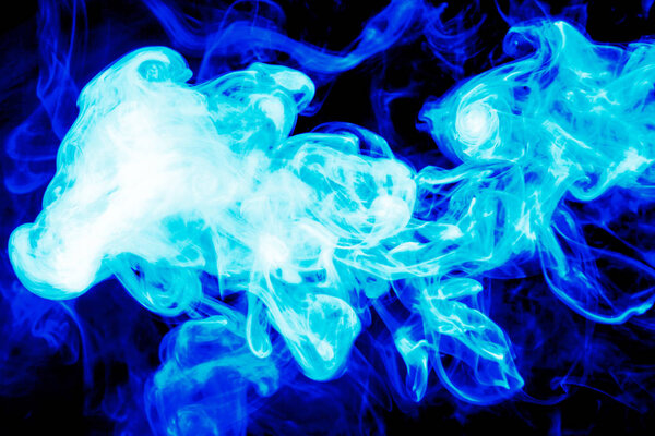 Cloud of blue smoke on a black isolated background. Background from the smoke of vape
