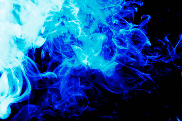 Cloud of blue smoke on a black isolated background. Background from the smoke of vape