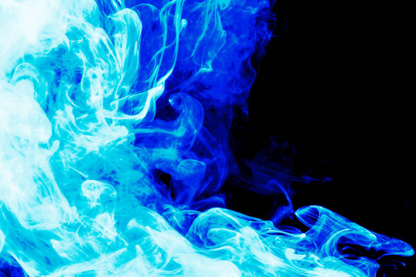 Dense blue smoke on a black isolated background. Background of smoke vape