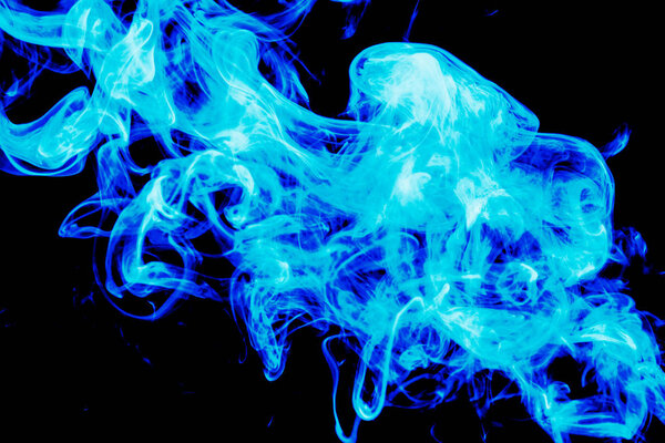 Dense blue smoke on a black isolated background. Background of smoke vape