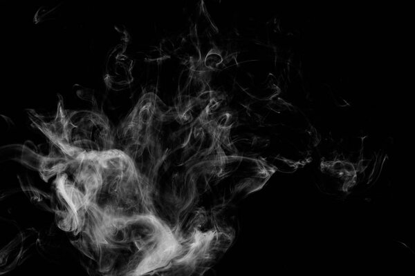 Cloud of white smoke on a black isolated background. Background from the smoke of vape