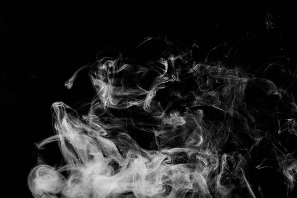 Dense white smoke on a black isolated background. Background of smoke vape