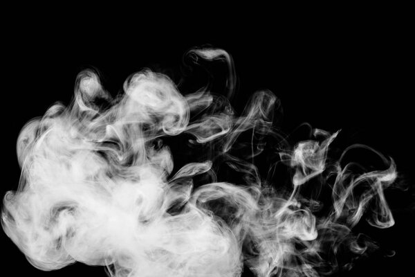 Dense white smoke on a black isolated background. Background of smoke vape