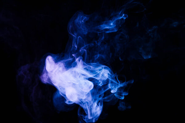 Dense multicolored smoke of blue colors on a black isolated background. Background of smoke vape